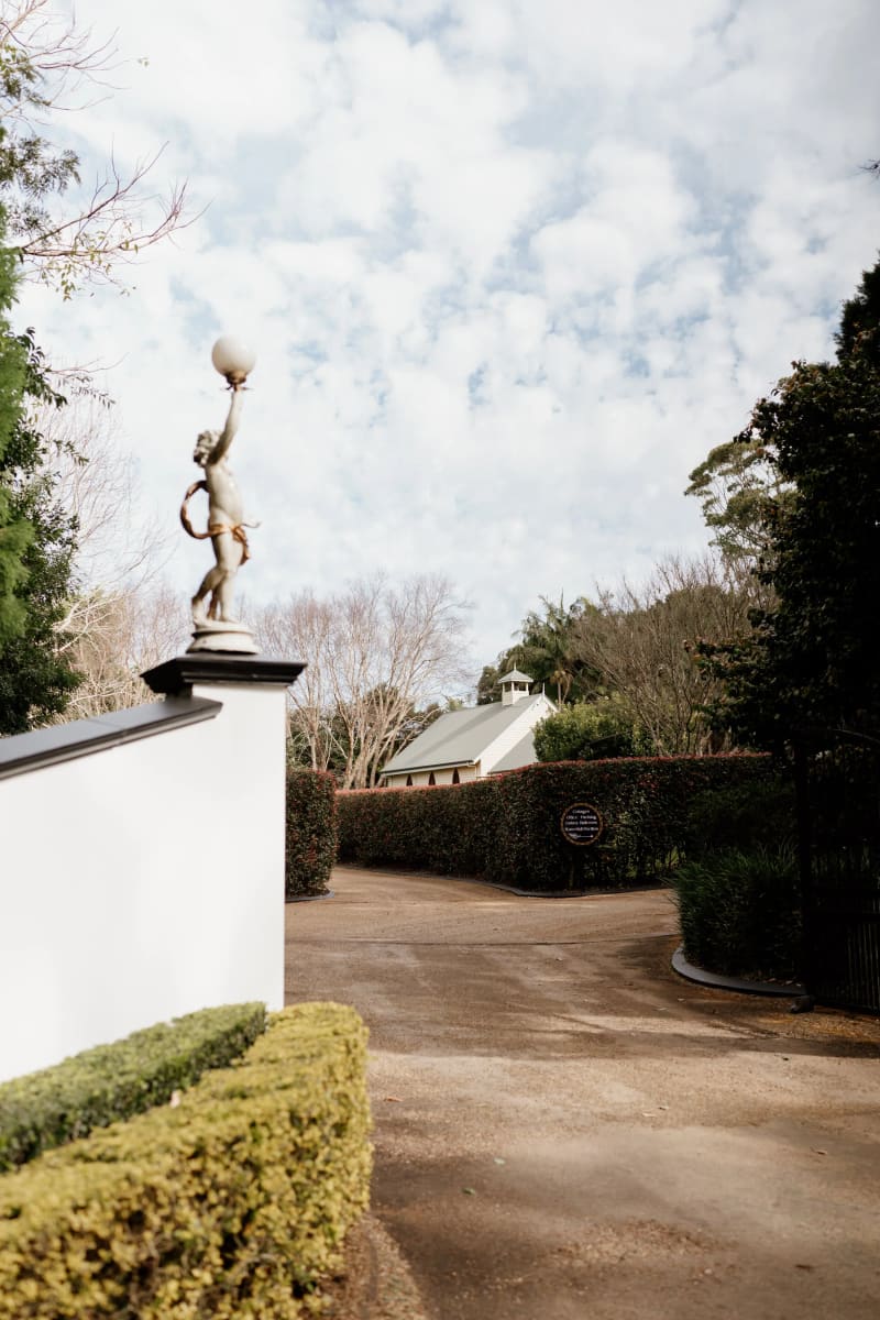 The driveway and gardens at the entrance to Shambala Estate